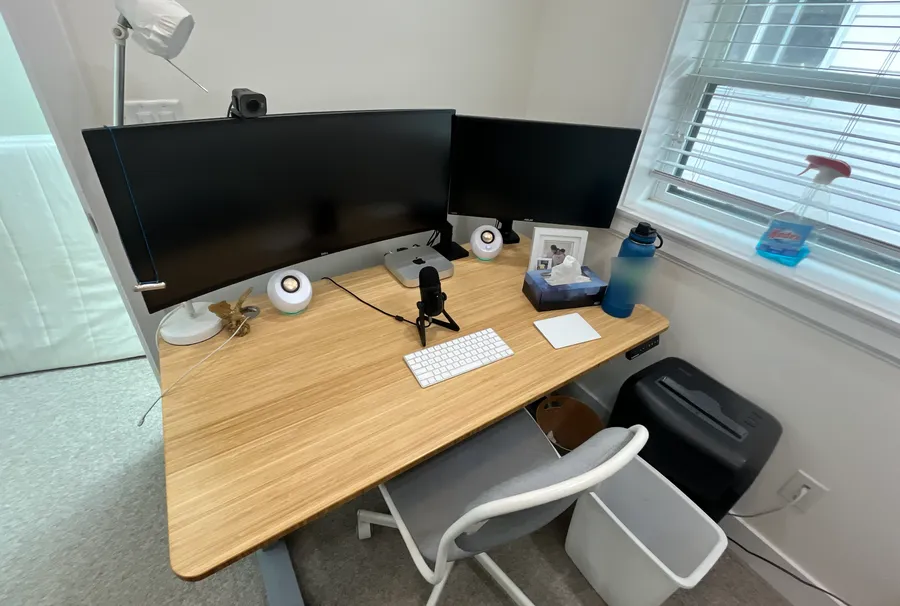 David's desk after: a clear desktop with monitors, keyboard and a family photo