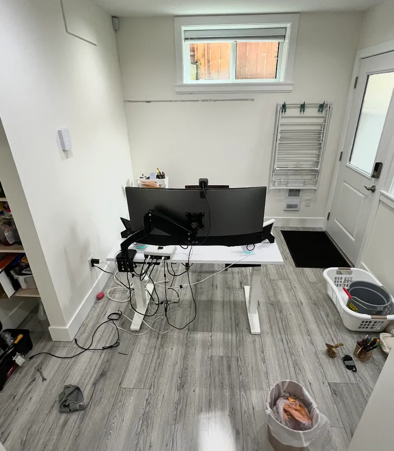 The second office after: the coat rack gone and the desk moved to face the window